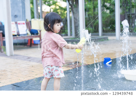 Japanese toddlers playing in the fountain at the apartment complex 129439748