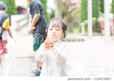 Japanese toddlers playing in the fountain at the apartment complex 129439807