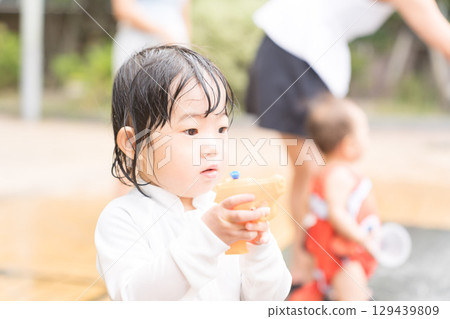 Japanese toddlers playing in the fountain at the apartment complex Japanese toddlers playing in the fountain at the apartment complex 129439809