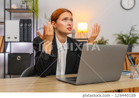 Young businesswoman spots debit credit error on laptop crumples paper throws it aside in panic today 129440189