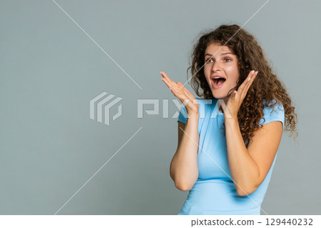Young amazed woman surprised mouth open amazed astonished reaction unexpected wow facial expression Young amazed woman surprised mouth open amazed astonished reaction unexpected wow facial expression 129440232
