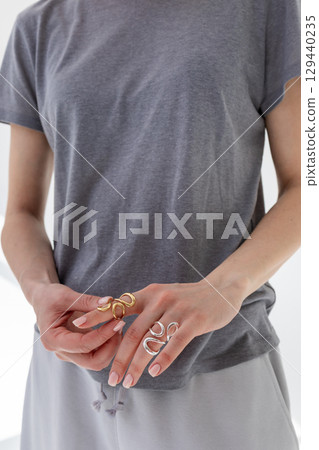Female hands with rings on their hands close-up. Vertical photo. High quality photo 129440235