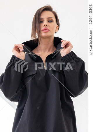 Portrait of beautiful woman in black jacket close-up on white background. Studio photography. Vertical photo. High quality photo 129440308