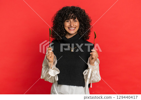 Hungry woman waiting for serving dinner meal dishes with restlessness holding cutlery fork knife Hungry woman waiting for serving dinner meal dishes with restlessness holding cutlery fork knife 129440417