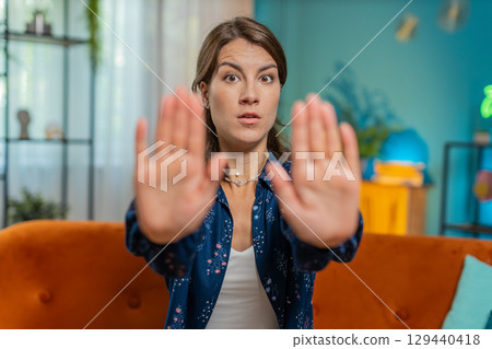 Woman says No hold palm folded crossed hands, warning of finish, prohibited access stop gesture Woman says No hold palm folded crossed hands, warning of finish, prohibited access stop gesture 129440418