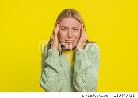 Woman rubbing temples to cure headache problem, suffering from tension and migraine stress pain Woman rubbing temples to cure headache problem, suffering from tension and migraine stress pain 129440421