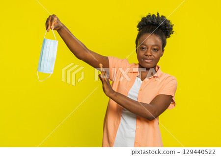 African American woman removing medical mask, relief from illness, returning to normal daily life 129440522