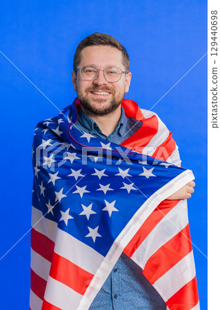 Man in glasses wrapped up in American USA flag, celebrating, human rights and freedoms, independence 129440698