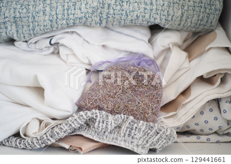 Organizing a closet with fresh linens and lavender sachets Organizing a closet with fresh linens and lavender sachets 129441661