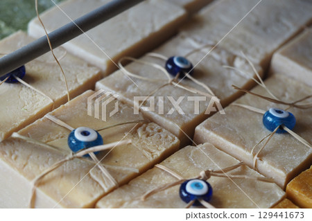 Handmade soap bars with decorative beads on display 129441673