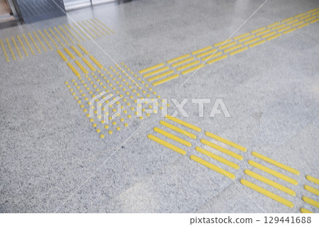 Yellow markings assist visually impaired people at the transit station Yellow markings assist visually impaired people at the transit station 129441688