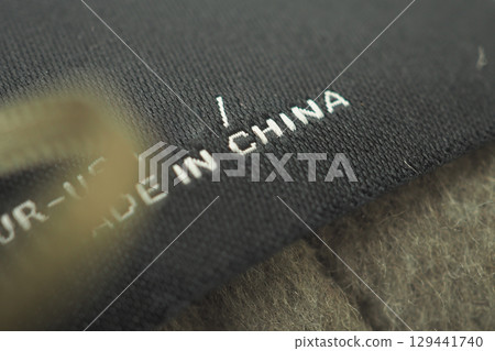 Text label showing manufacturing origin on fabric 129441740