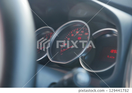 Speedometer shows vehicle speed during daylight drive 129441782