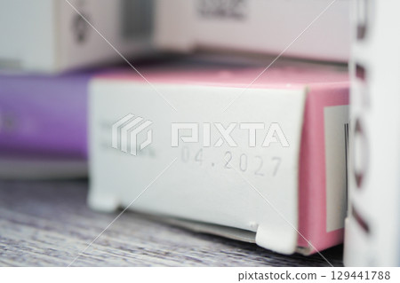 Expired product packaging with date in focus 129441788