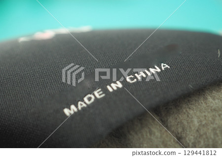 Black fabric tag with Made in China label visible 129441812