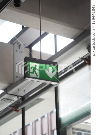 Emergency exit sign displayed in a modern building interior Emergency exit sign displayed in a modern building interior 129441842