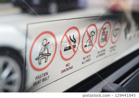 Safety and policy signs visible in a vehicle Safety and policy signs visible in a vehicle 129441845