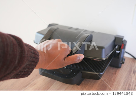 Grilling delicious food with a electric grill at home 129441848