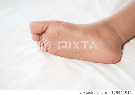 Close-up view of a bare foot resting on a white surface 129441914