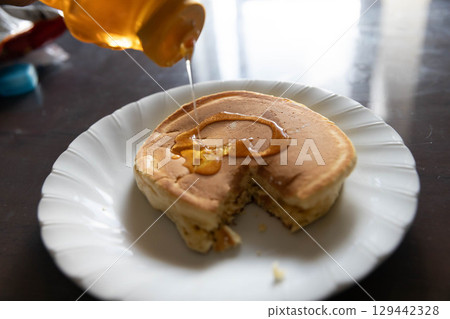 Homemade pancake, half-eaten 129442328