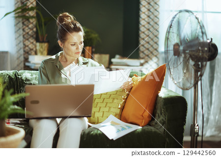 Intent Woman Managing Finances from Home Office 129442560