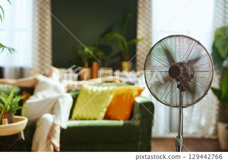 Summer Comfort: Relaxing with a Pedestal Fan Summer Comfort: Relaxing with a Pedestal Fan 129442766