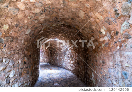 Curving stone tunnel with an arched ceiling and paved floor, leading to the Museum of Maya Sculpture at the Copan archaeological site in Honduras Curving stone tunnel with an arched ceiling and paved floor, leading to the Museum of Maya Sculpture at the Copan archaeological site in Honduras 129442906