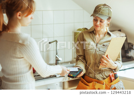Home Repair Payment: Card Transaction in Kitchen Home Repair Payment: Card Transaction in Kitchen 129443218