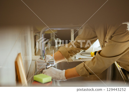 Fixing Faucet: Kitchen Sink Maintenance 129443252
