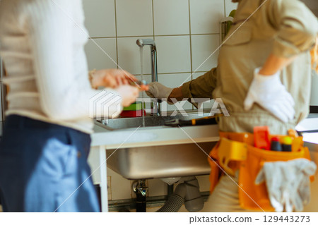 Plumber Repairs Kitchen Faucet 129443273