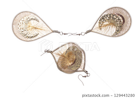 Fashion gold Earrings with beautiful work detail is value. Luxury golden earring is fashion trend and fly in air. White background isolated Fashion gold Earrings with beautiful work detail is value. Luxury golden earring is fashion trend and fly in air. White background isolated 129443280