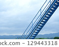Cloudy sky and diagonal blue stairs 129443318