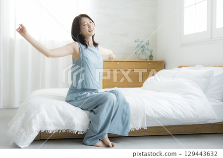 Woman relaxing in bed Woman relaxing in bed 129443632