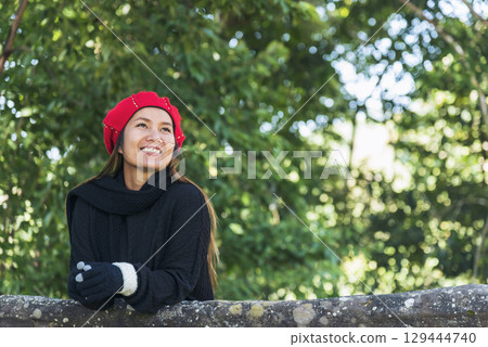 Portrait Asian Woman relaxing in green park. Happy Relax asian woman smiling face at outdoors garden. Young women enjoy nature freedom lifestyle. Greenery wellbeing outside beauty in nature. Portrait Asian Woman relaxing in green park. Happy Relax asian woman smiling face at outdoors garden. Young women enjoy nature freedom lifestyle. Greenery wellbeing outside beauty in nature. 129444740