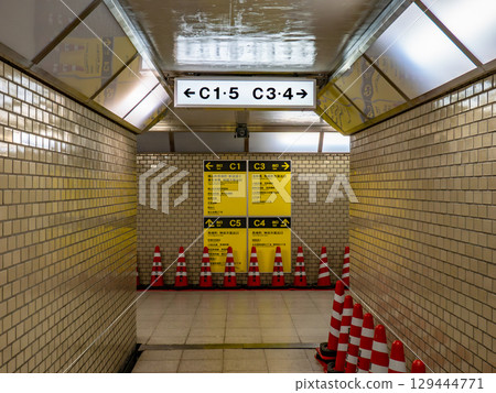Exit signs posted on the underground walkway 129444771