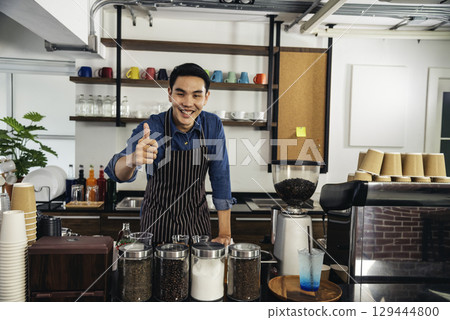 Portrait barista Asian man coffee shop owner smiling look at camera small business confident person Entrepreneur manager professional men standing coffee counter bar. Barista small business Owner Portrait barista Asian man coffee shop owner smiling look at camera small business confident person Entrepreneur manager professional men standing coffee counter bar. Barista small business Owner 129444800