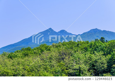 A stroll around the Shiretoko Five Lakes on Hokkaido's Shiretoko Peninsula under a clear blue June sky. The mountains and virgin forests reflected on the lake's surface are beautiful. A stroll around the Shiretoko Five Lakes on Hokkaido's Shiretoko Peninsula under a clear blue June sky. The mountains and virgin forests reflected on the lake's surface are beautiful. 129446023