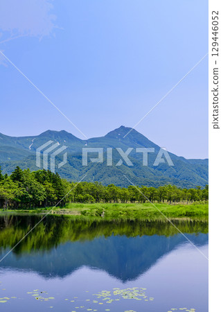 A stroll around the Shiretoko Five Lakes on Hokkaido's Shiretoko Peninsula under a clear blue June sky. The mountains and virgin forests reflected on the lake's surface are beautiful. 129446052