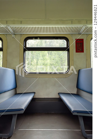 Empty old train compartment interior with blue seats. 129446821