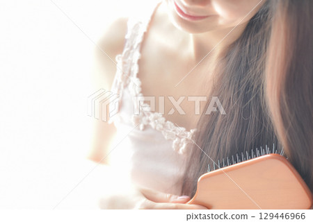 Woman combing her tangled hair 129446966