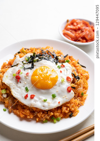 Korean kimchi fried rice with fried egg, pork, sesame seed, chili, spring onion and seaweed 129447095