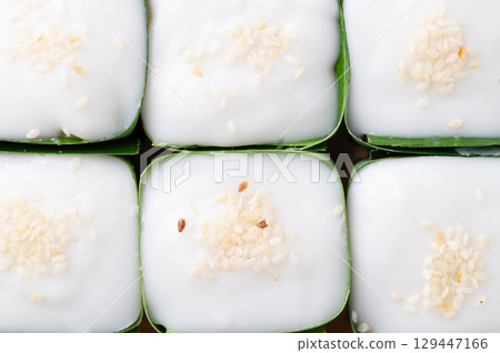 Traditional Thai dessert (Khanom Tako), Pudding with coconut cream topping in pandan leaf 129447166