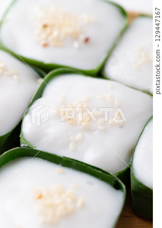 Traditional Thai dessert (Khanom Tako), Pudding with coconut cream topping in pandan leaf 129447167