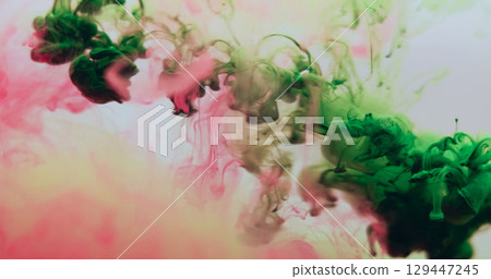 Underwater smoke. Floating paint. Colorful drop haze green pink liquid dissolve pigment. Art chemical splash abstract blur background. Underwater smoke. Floating paint. Colorful drop haze green pink liquid dissolve pigment. Art chemical splash abstract blur background. 129447245