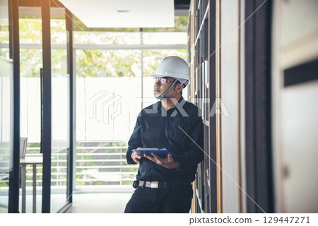 Man construction engineer writing note wear blue shirt safety white hard hat at construction site. Industry labour male worker. Architecture man drawing engineer civil constrcution real estate Man construction engineer writing note wear blue shirt safety white hard hat at construction site. Industry labour male worker. Architecture man drawing engineer civil constrcution real estate 129447271