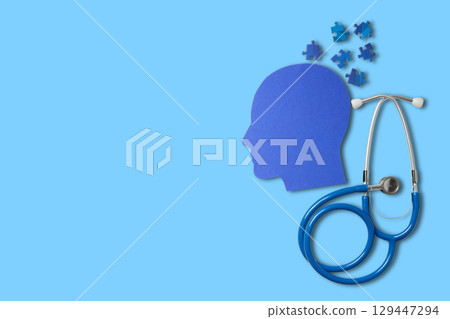 Stethoscope near a head silhouette filled with puzzles Stethoscope near a head silhouette filled with puzzles 129447294