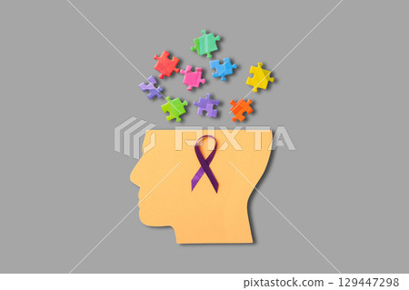 Colorful puzzle pieces and ribbon illustrate mental health 129447298