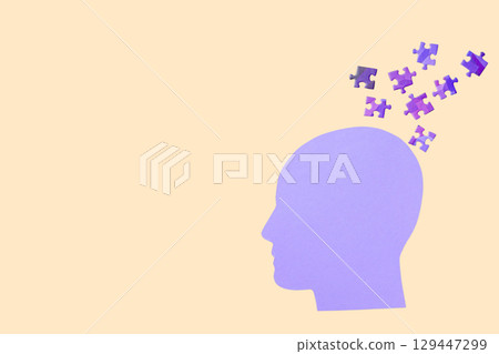 Silhouette with floating puzzle pieces symbolizes creativity 129447299