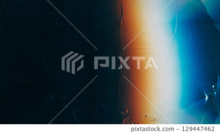 Scratched black glass. Damaged texture. Vintage dust cracked dark screen. Colorful light blur glow abstract night background free space. Scratched black glass. Damaged texture. Vintage dust cracked dark screen. Colorful light blur glow abstract night background free space. 129447462