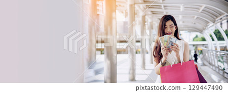 Banner Shopping bags of women crazy shopaholic person at fashion mall. Web Banner Woman love online shopping website holding shopping bags in hands with copy space. digital marketing happy lifestyle 129447490